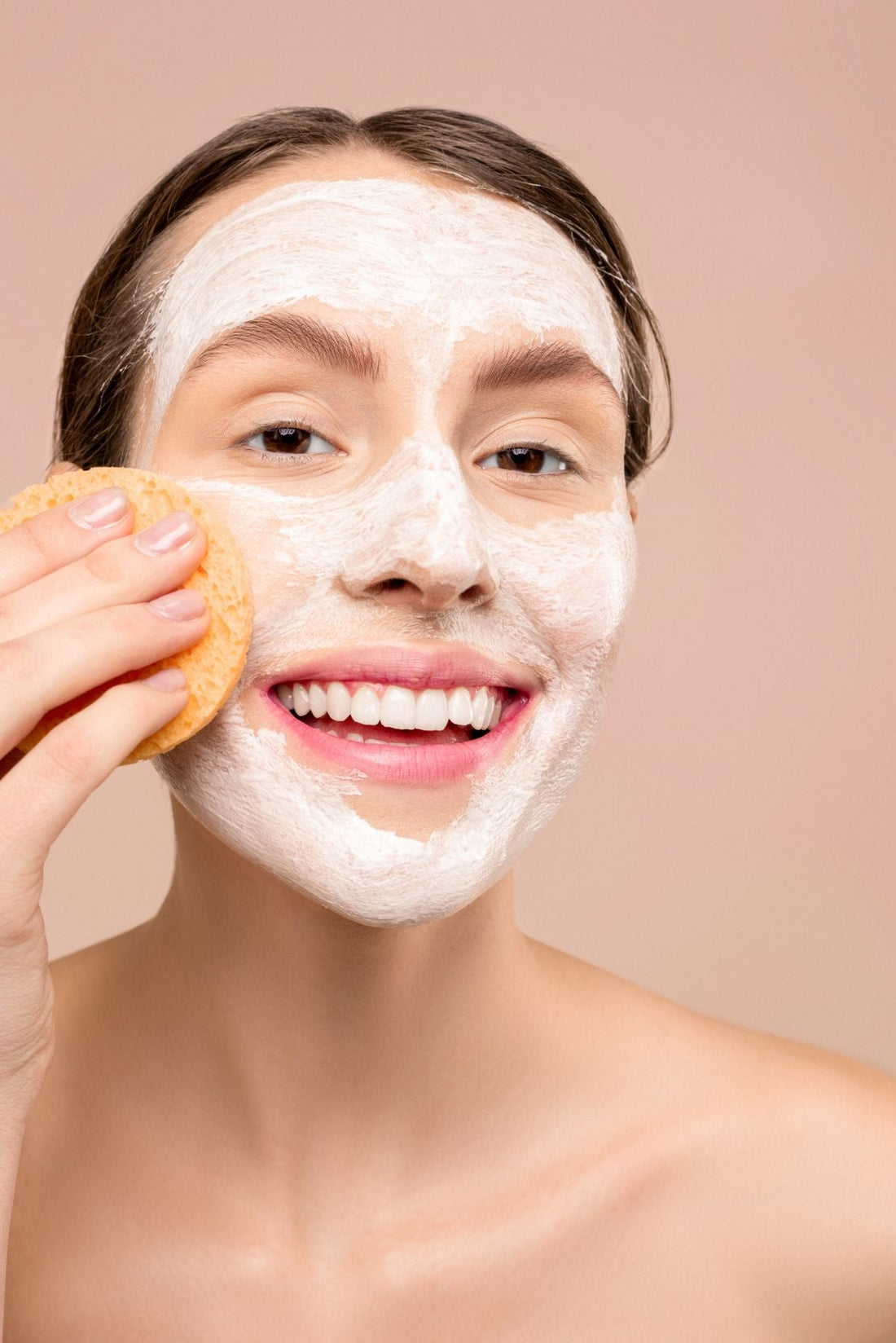 Woman applying serum to her face as part of her skincare routine