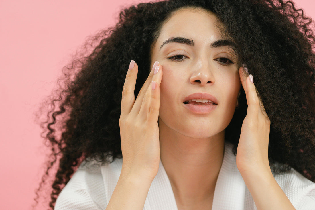 Woman applying skincare cream as part of her evening routine